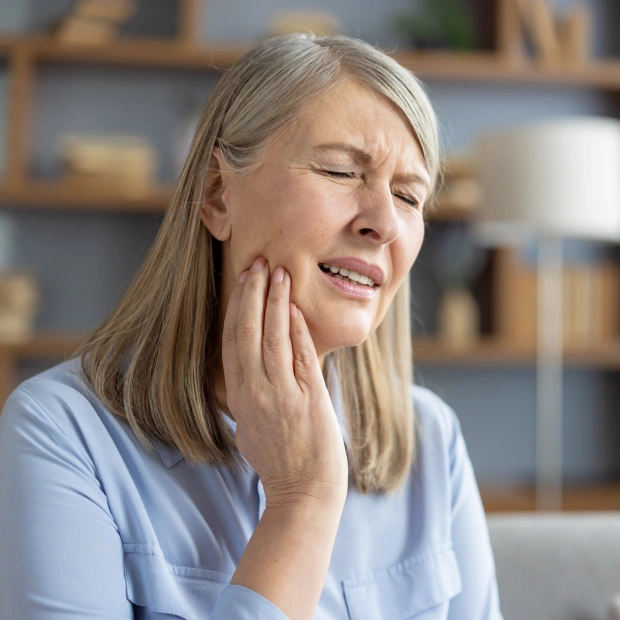 Patient experiencing tooth pain before extraction treatment